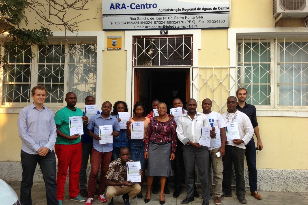 Participants proudly showing their certificates.